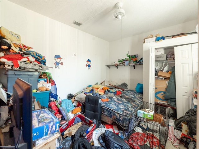 bedroom with visible vents, a textured ceiling, and a closet