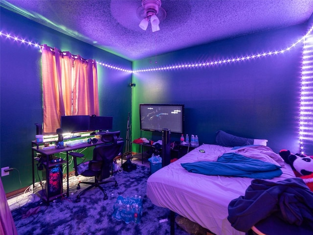 carpeted bedroom with a ceiling fan and a textured ceiling