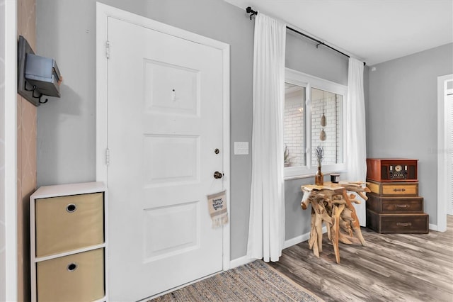 foyer with wood finished floors and baseboards