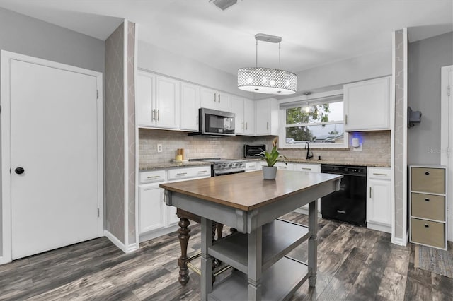 kitchen featuring decorative backsplash, white cabinets, appliances with stainless steel finishes, and dark wood-style flooring