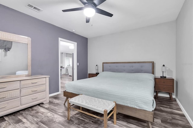 bedroom featuring visible vents, baseboards, and wood finished floors