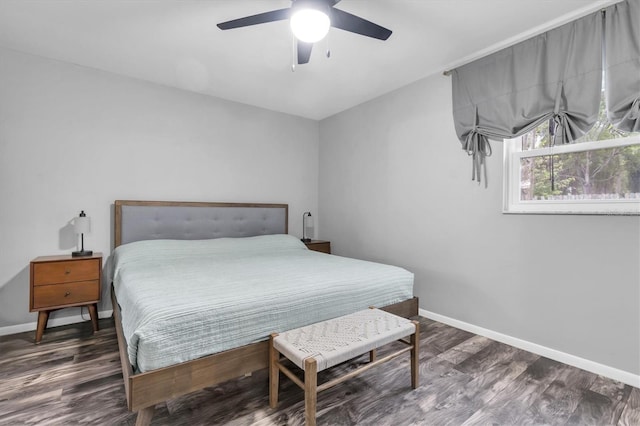 bedroom with ceiling fan, baseboards, and wood finished floors