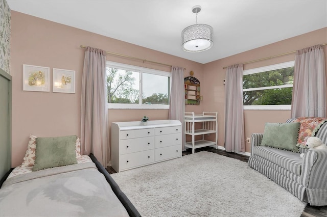 bedroom featuring baseboards and multiple windows