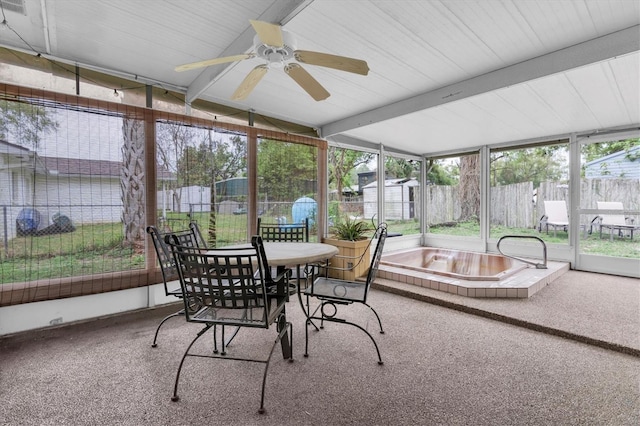 sunroom with beam ceiling and a ceiling fan