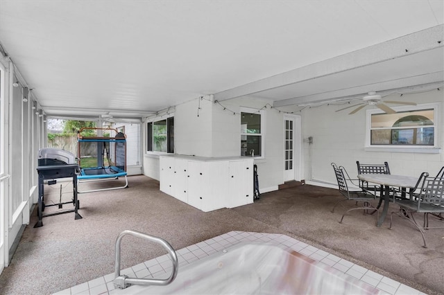 view of patio / terrace featuring outdoor dining area, a ceiling fan, and a trampoline