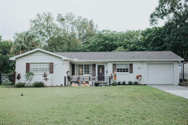 ranch-style house featuring a garage, driveway, brick siding, and a front yard