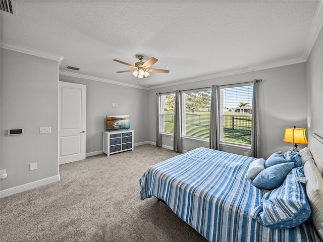 bedroom featuring visible vents, carpet, crown molding, and a textured ceiling