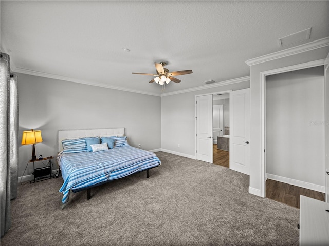 carpeted bedroom with attic access, crown molding, visible vents, and baseboards