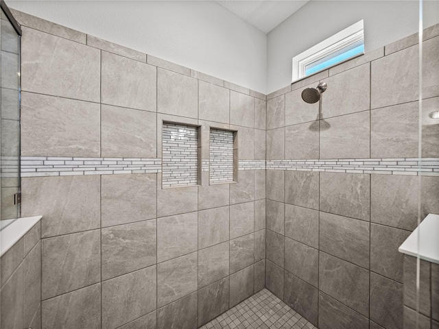 full bath featuring tiled shower