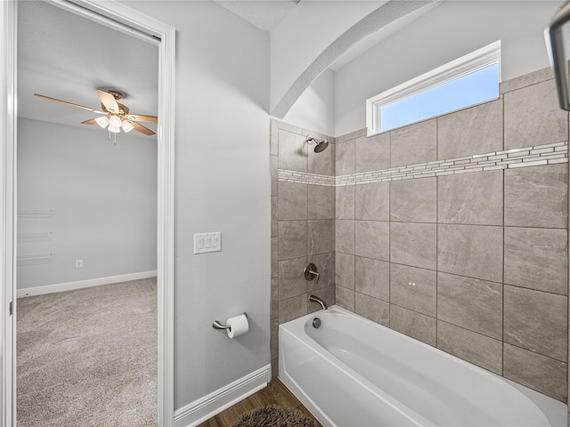 full bath featuring a ceiling fan, baseboards, and shower / washtub combination