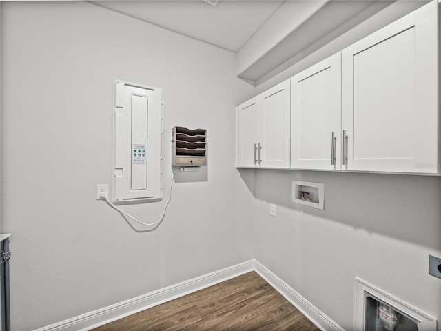 laundry area featuring baseboards, washer hookup, cabinet space, hookup for an electric dryer, and dark wood-style flooring