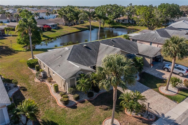 drone / aerial view featuring a residential view and a water view