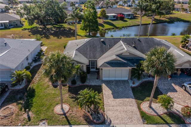 birds eye view of property featuring a water view and a residential view