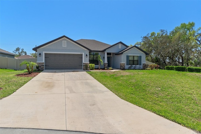 view of front of home featuring fence, a front yard, a garage, stone siding, and driveway