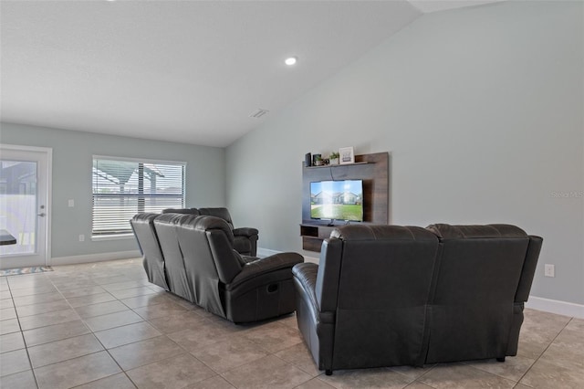 living room with light tile patterned flooring, baseboards, and lofted ceiling