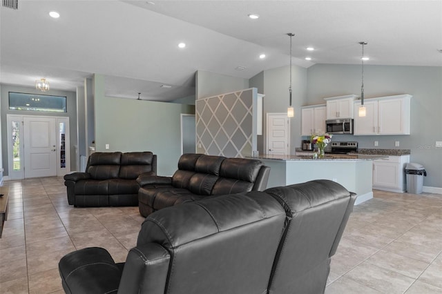 living room featuring light tile patterned floors, recessed lighting, and baseboards