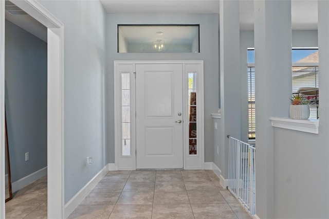 foyer with light tile patterned floors and baseboards