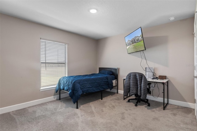 carpeted bedroom featuring baseboards