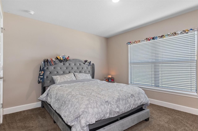 carpeted bedroom featuring baseboards