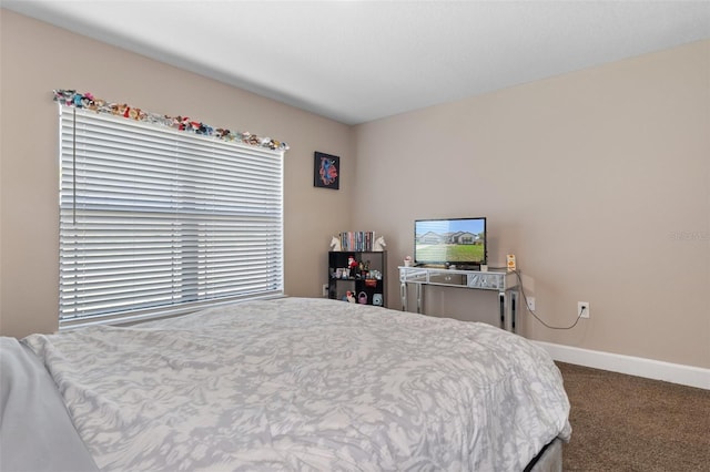 bedroom with baseboards and carpet floors