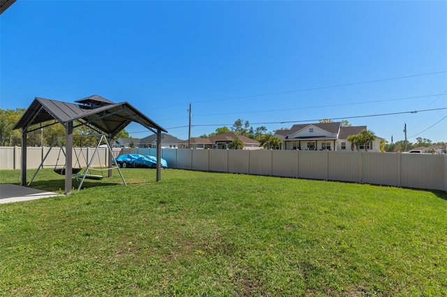 view of yard featuring a gazebo and a fenced backyard