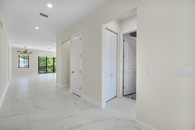 corridor featuring visible vents, recessed lighting, marble finish floor, and baseboards