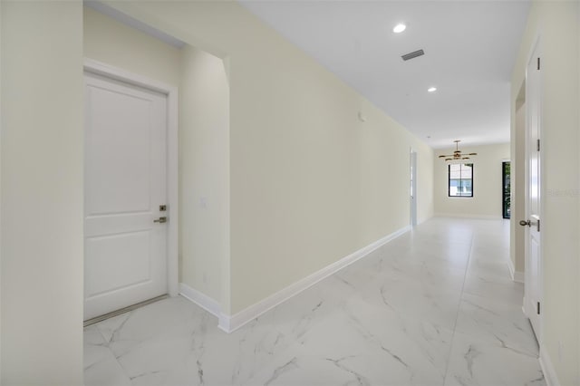 hallway with recessed lighting, visible vents, baseboards, and marble finish floor