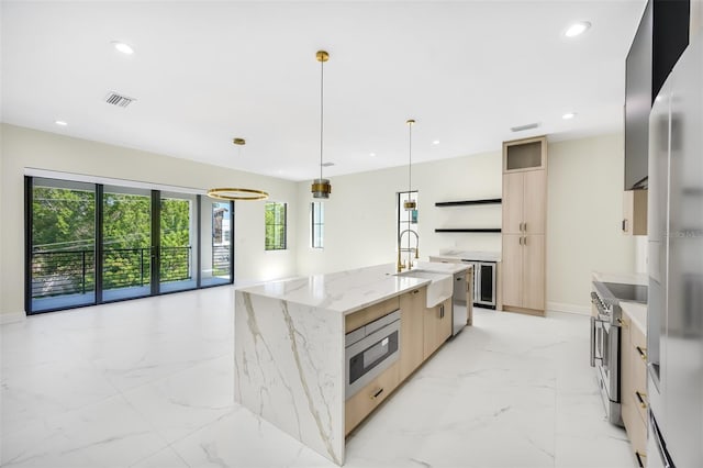 kitchen featuring a sink, light brown cabinetry, stainless steel appliances, modern cabinets, and marble finish floor