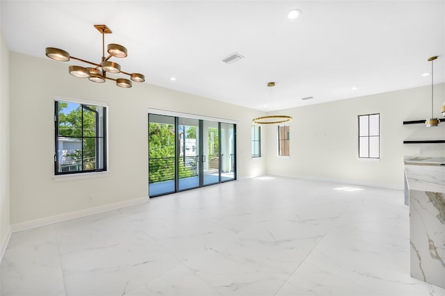 empty room with visible vents, marble finish floor, and baseboards