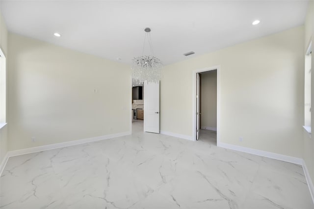 spare room featuring recessed lighting, visible vents, marble finish floor, and baseboards