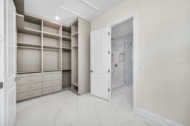 walk in closet featuring attic access and marble finish floor