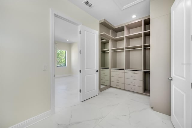 walk in closet with visible vents and marble finish floor