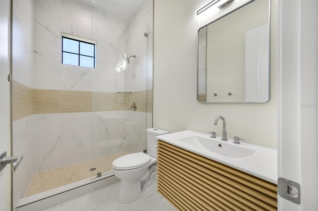 full bath featuring a marble finish shower, marble finish floor, toilet, and vanity