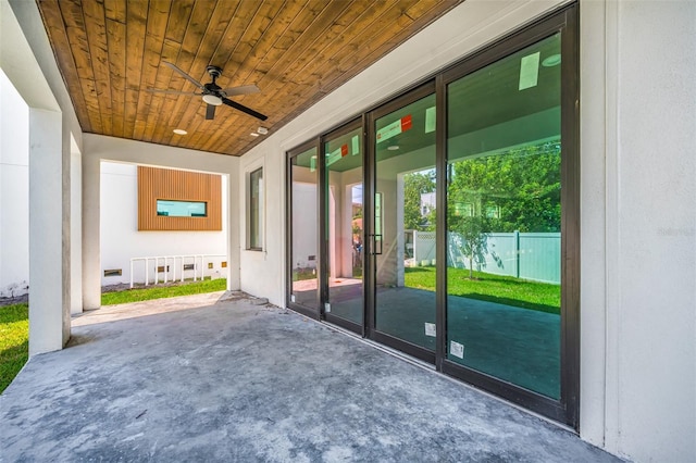 view of patio with fence and ceiling fan