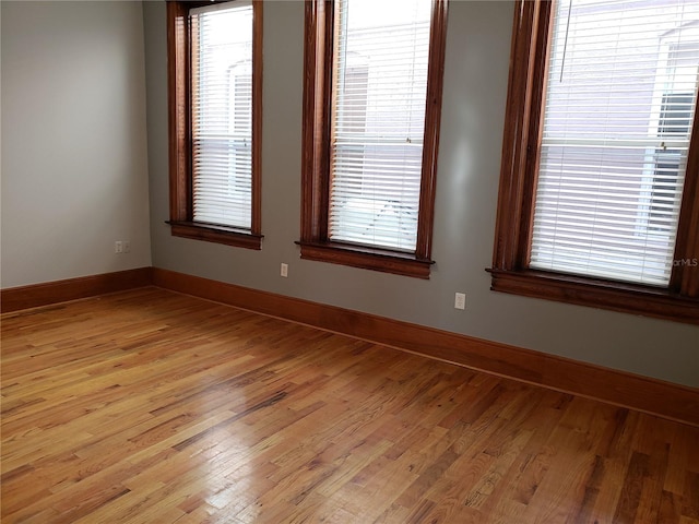 unfurnished room featuring light wood-style flooring and baseboards