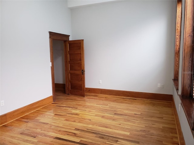 unfurnished room featuring light wood-style flooring and baseboards