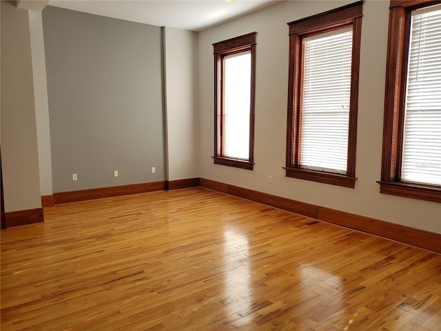 empty room featuring light wood-style floors and baseboards