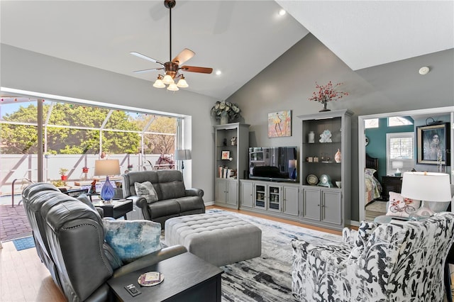 living area featuring a ceiling fan, recessed lighting, wood finished floors, and high vaulted ceiling