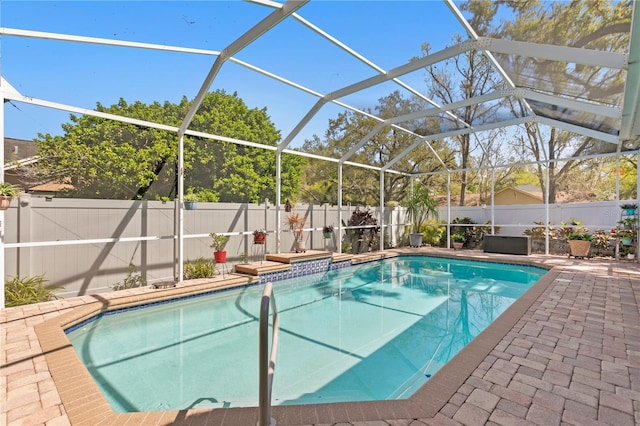 view of pool featuring a lanai, a fenced in pool, and a fenced backyard