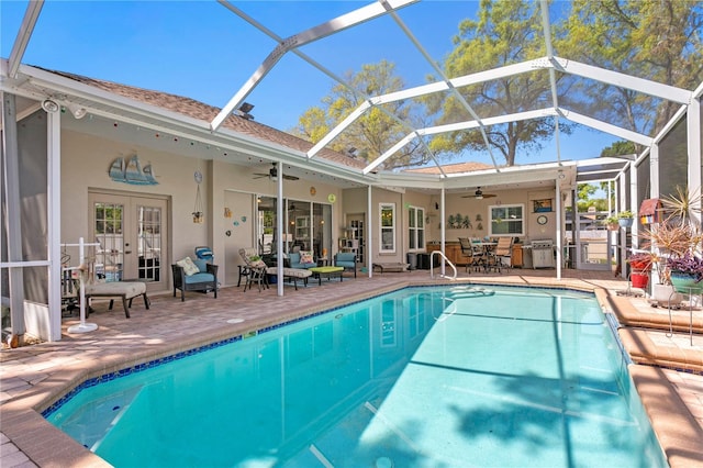 outdoor pool with grilling area, french doors, a ceiling fan, and a patio