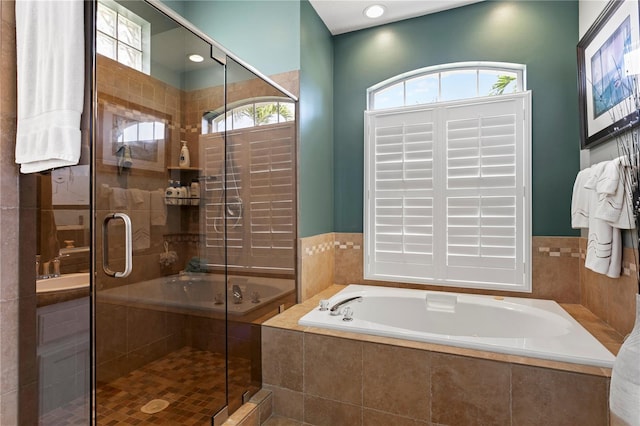 full bathroom featuring a shower stall and a bath