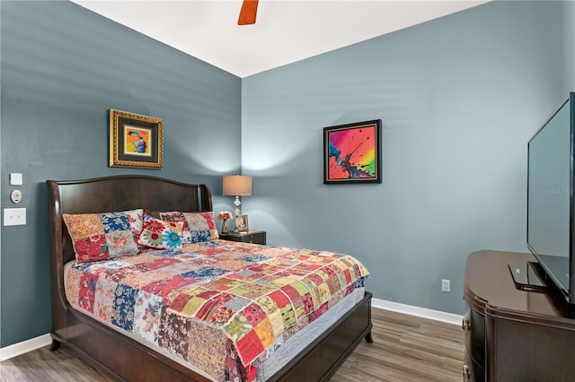 bedroom with wood finished floors, baseboards, and ceiling fan