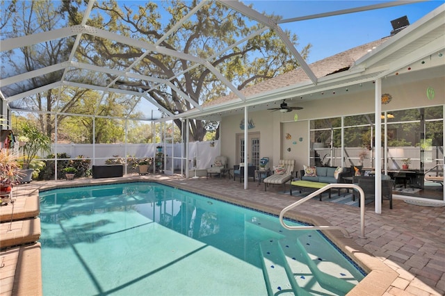 view of swimming pool with fence, a lanai, outdoor lounge area, and a patio area