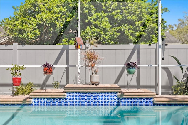 view of pool with a fenced in pool and fence