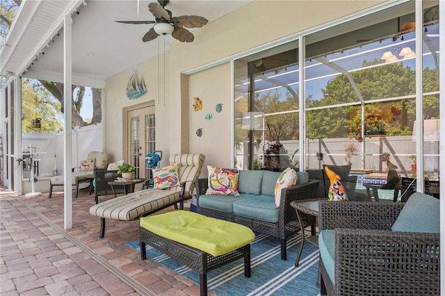 view of patio featuring an outdoor living space, fence, french doors, glass enclosure, and ceiling fan