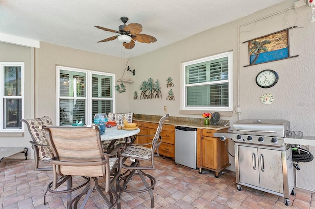 exterior space featuring ceiling fan, outdoor dining space, and exterior kitchen