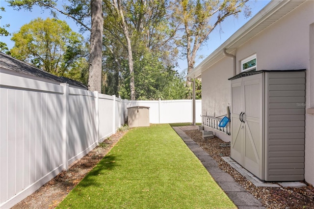 view of yard with an outdoor structure and a fenced backyard