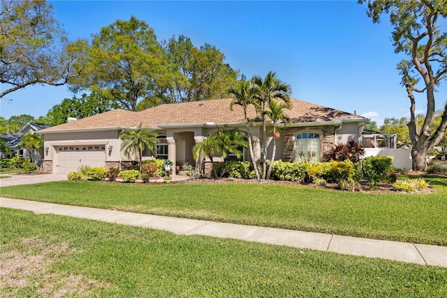 view of front of house featuring a front yard, stucco siding, driveway, stone siding, and an attached garage