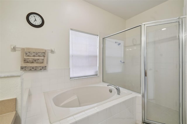 bathroom featuring a bath and a stall shower