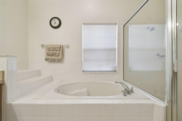 bathroom featuring a garden tub and a shower with shower door